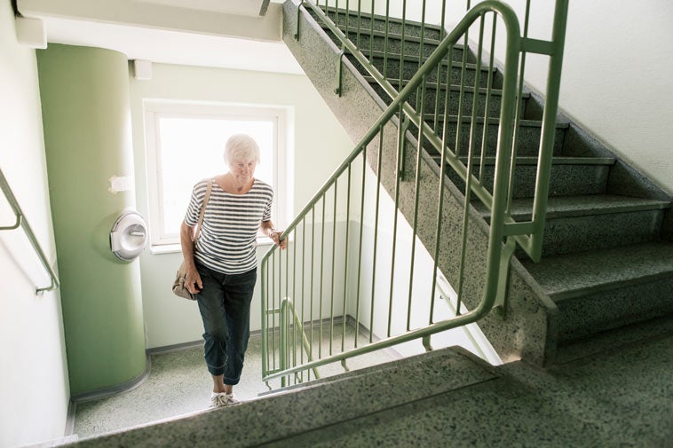 Older woman walking up steps