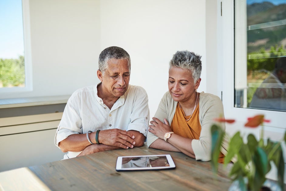 Mature couple looking at tablet together